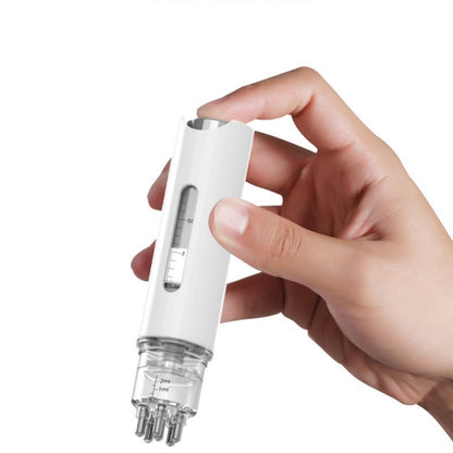 Hand holding a White scalp serum applicator with a measurement window and roller-ball head
