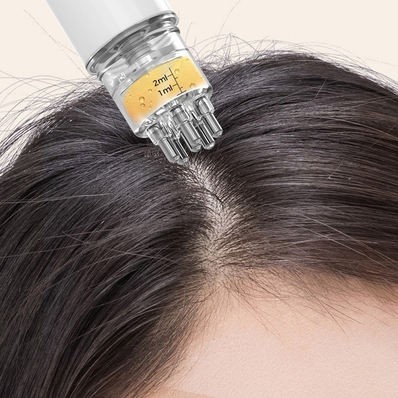 White scalp serum applicator with multiple roller balls positioned along a hair part