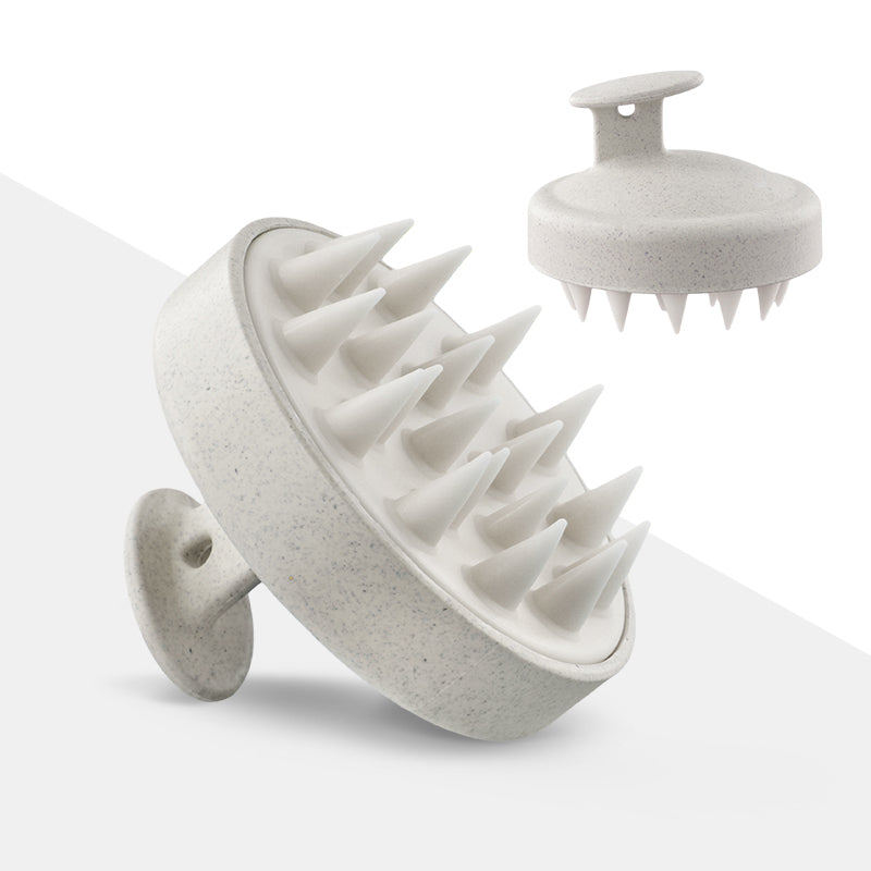 White round palm-held scalp shampoo brush showing silicone massage teeth and a small top grip